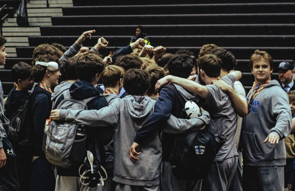 The South River Wrestling team huddled at a match.